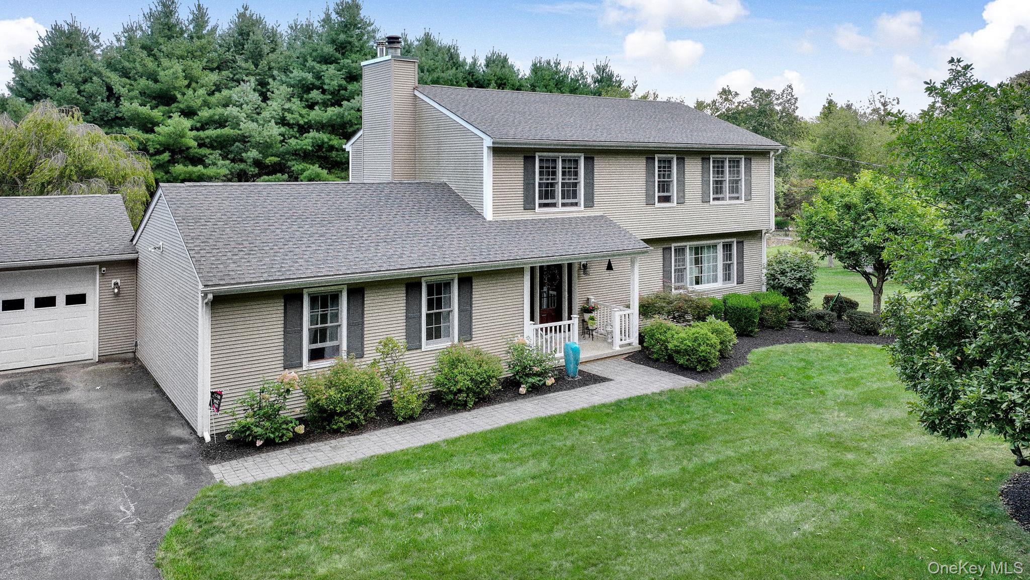 a view of a house with garden and yard