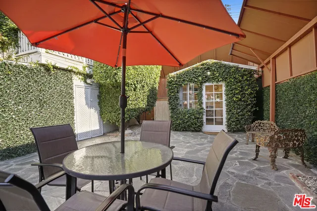 an aerial view of a house with a garden and lake view
