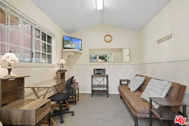 a view of a patio with a table and chairs under an umbrella