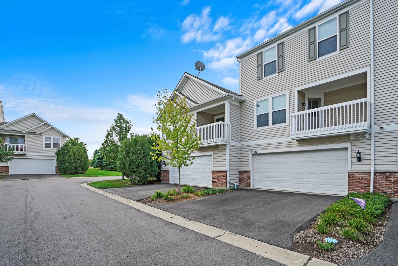 2602 Neubauer Circle Lindenhurst, IL 60046 - Photo 20 of 25 a front view of a house with a yard and garage
