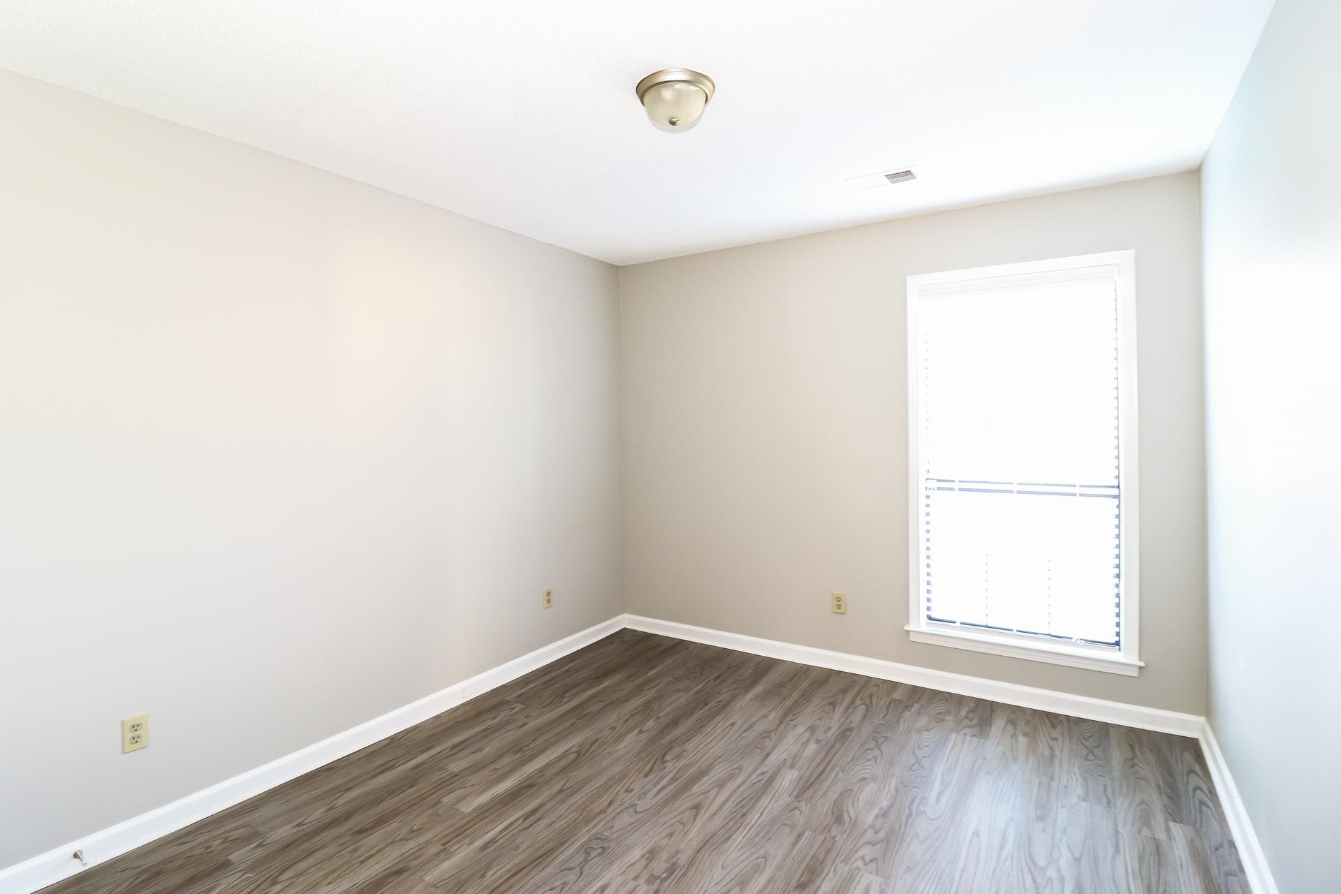 5921 Pecan Trace Memphis, TN 38135 - Photo 11 of 16 Empty room featuring wood finished floors and baseboards