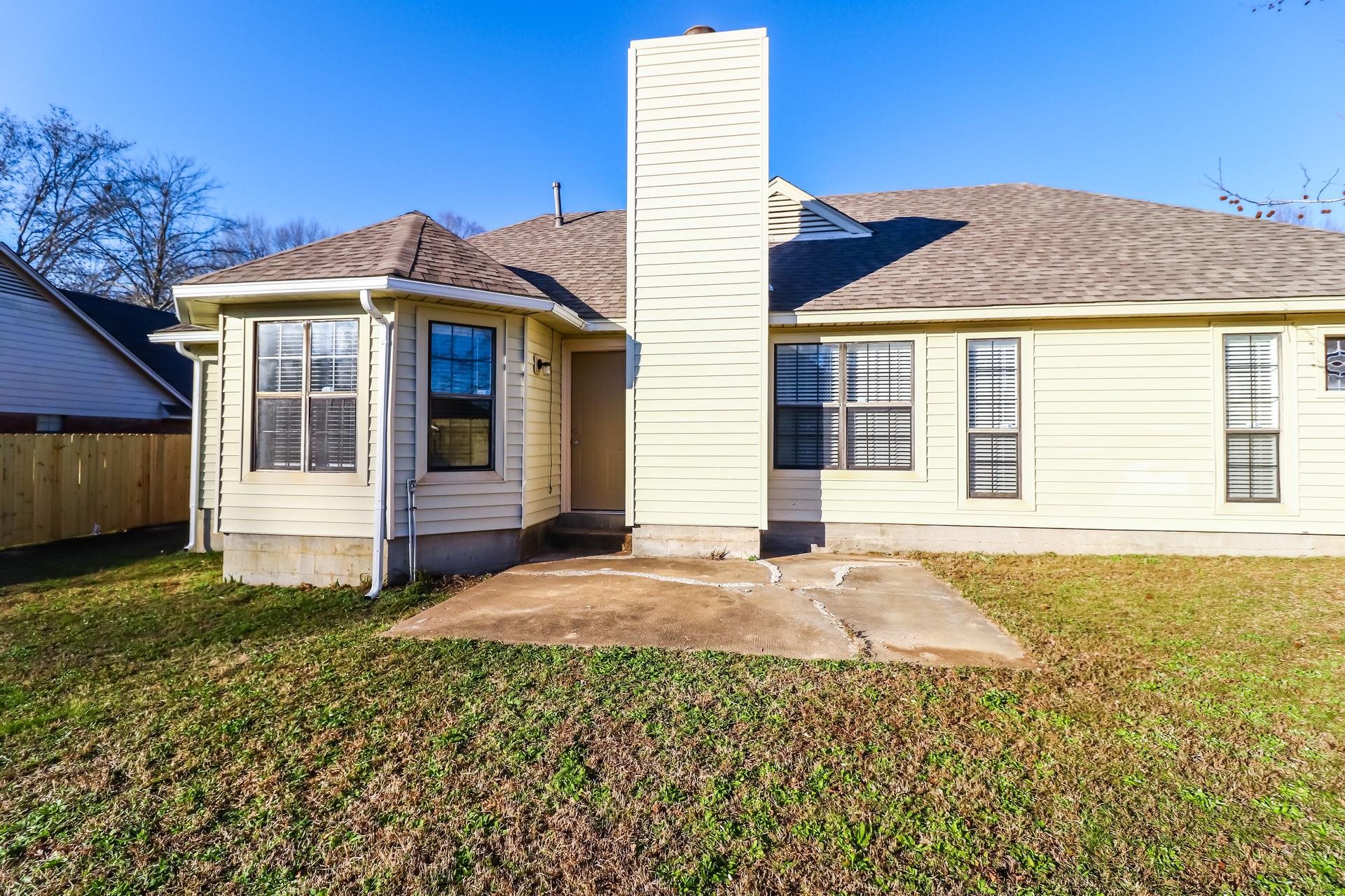 5921 Pecan Trace Memphis, TN 38135 - Photo 13 of 16 Rear view of property with roof with shingles, a patio, and a chimney