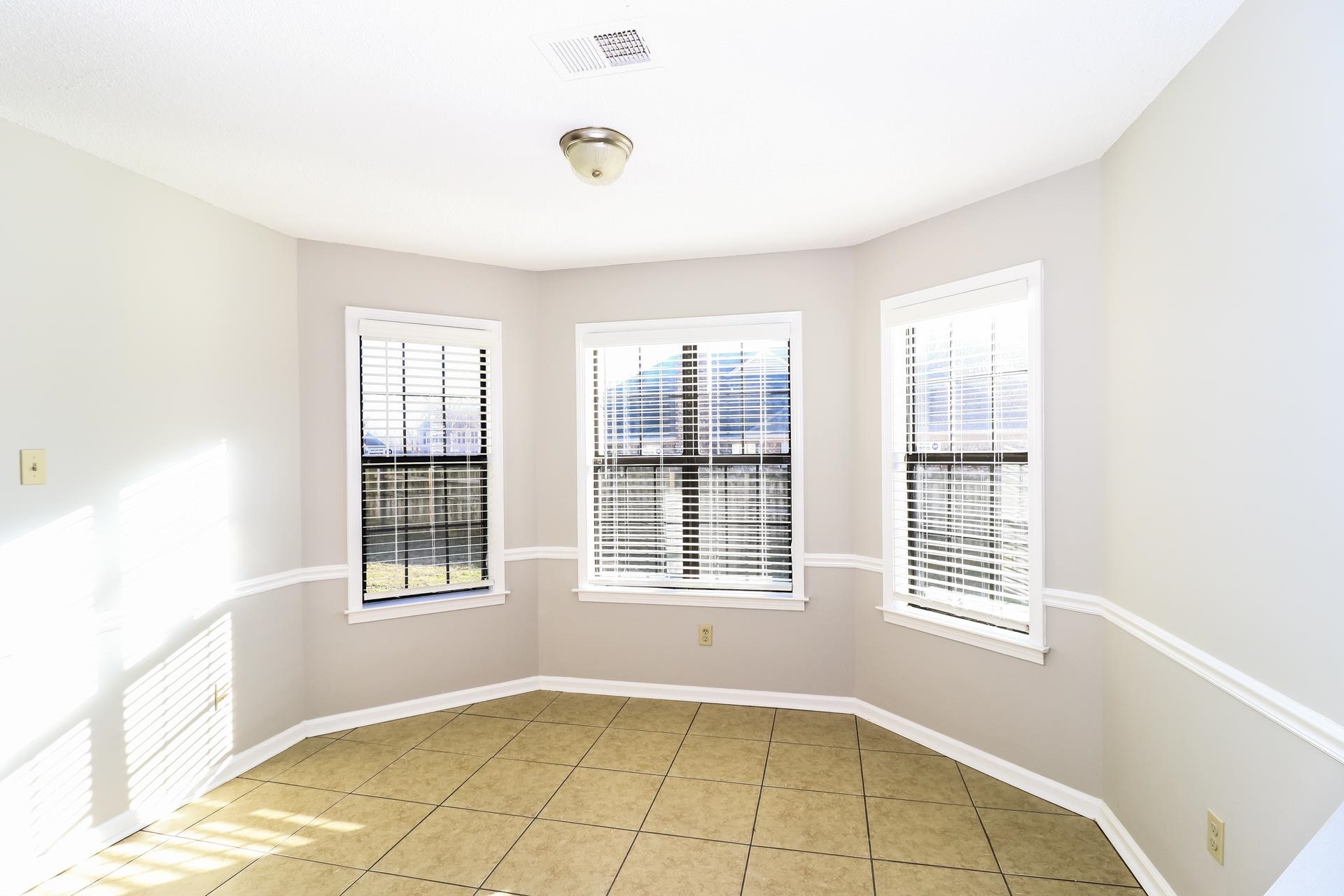 5921 Pecan Trace Memphis, TN 38135 - Photo 5 of 16 Empty room featuring light tile patterned floors and plenty of natural light