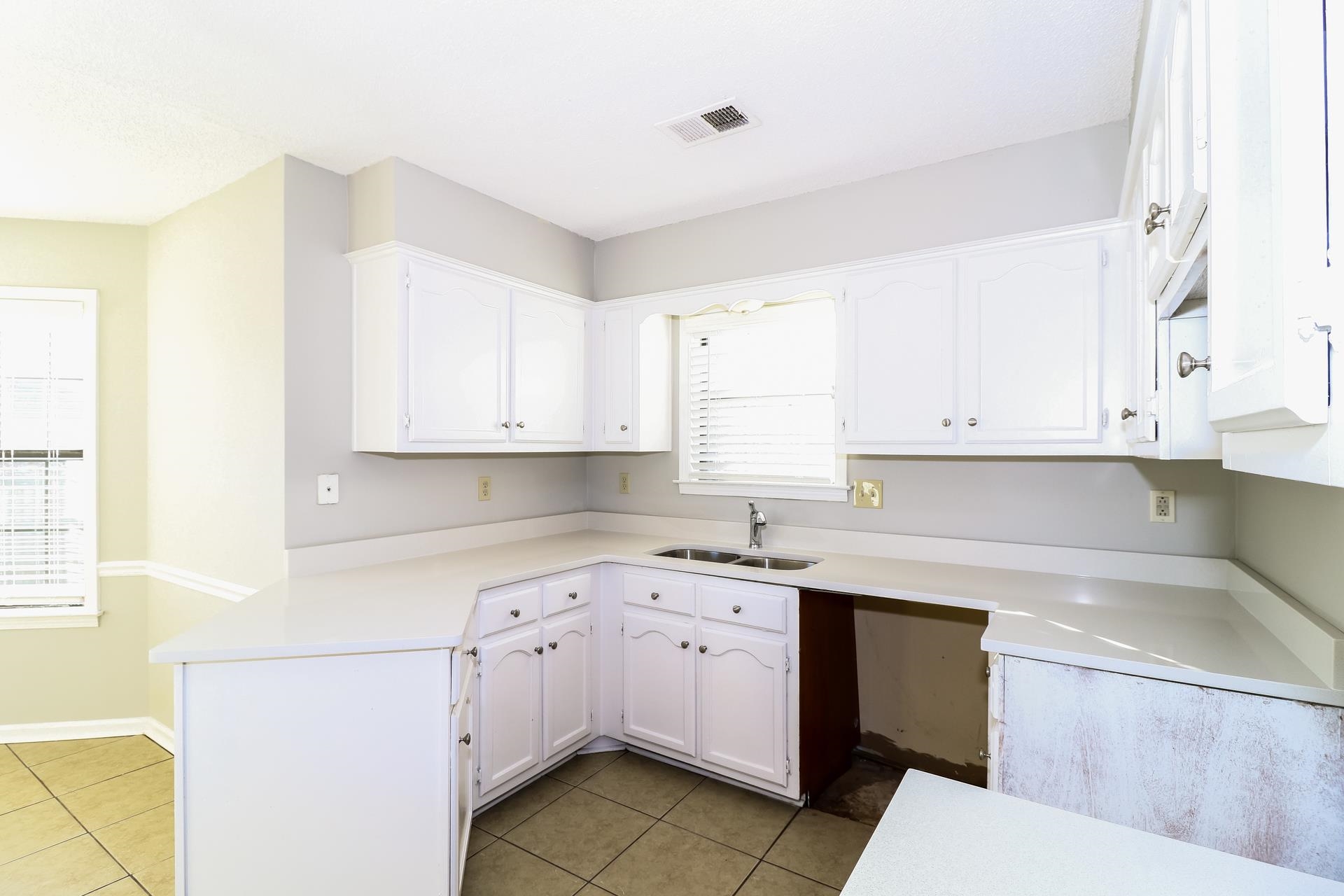 5921 Pecan Trace Memphis, TN 38135 - Photo 6 of 16 Kitchen with white cabinets and light tile patterned floors
