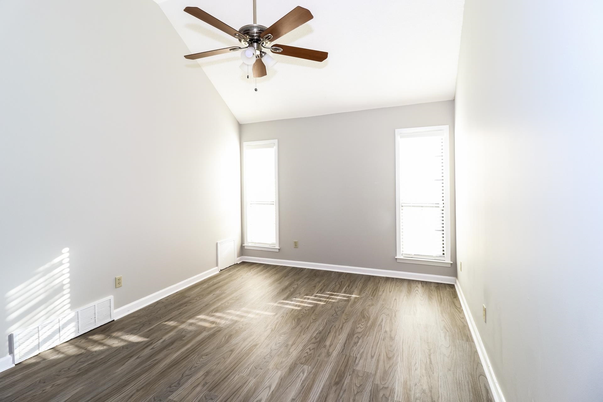 5921 Pecan Trace Memphis, TN 38135 - Photo 8 of 16 Unfurnished room featuring dark wood-style flooring, a ceiling fan, and high vaulted ceiling