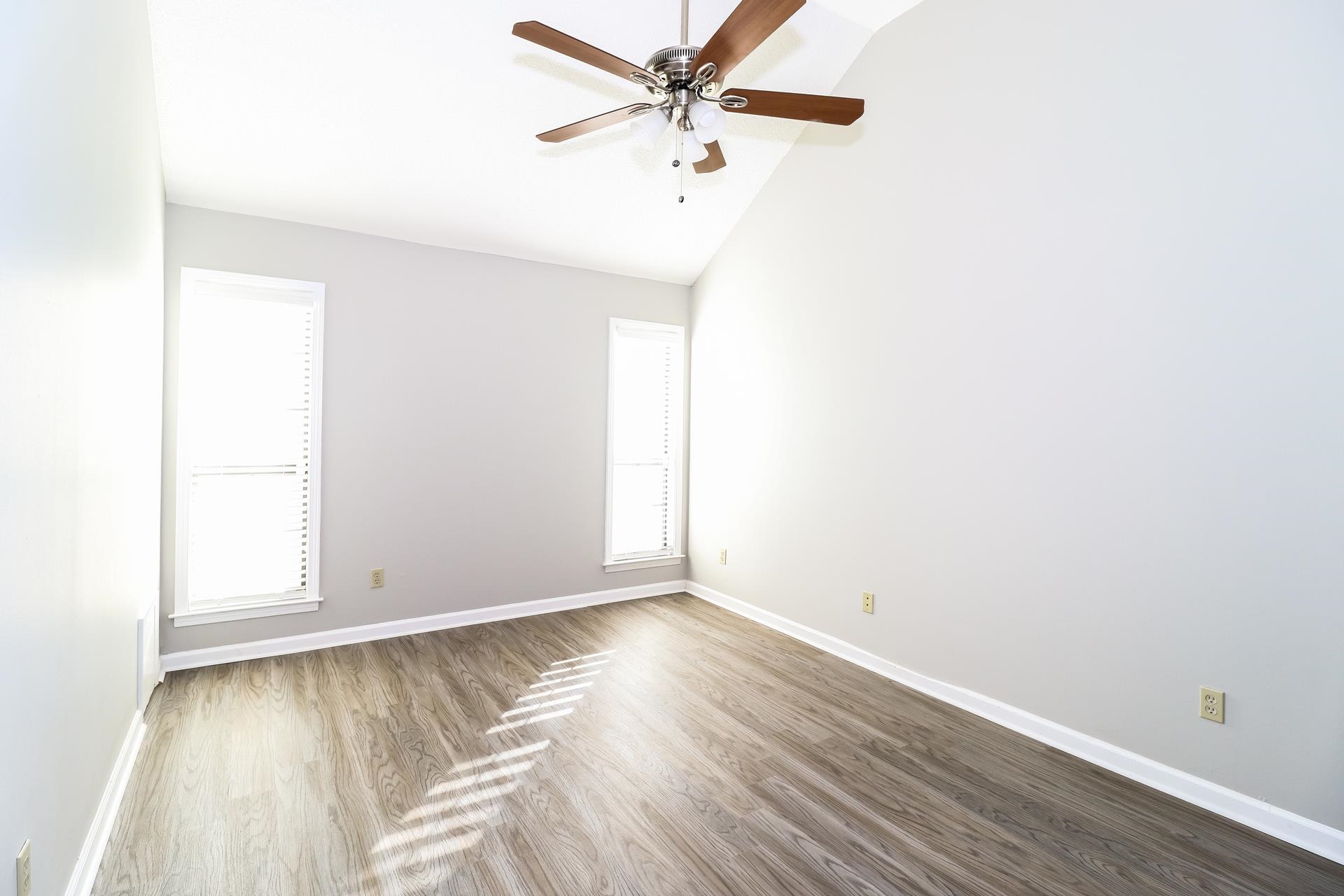 5921 Pecan Trace Memphis, TN 38135 - Photo 9 of 16 Empty room featuring wood finished floors, a ceiling fan, and high vaulted ceiling