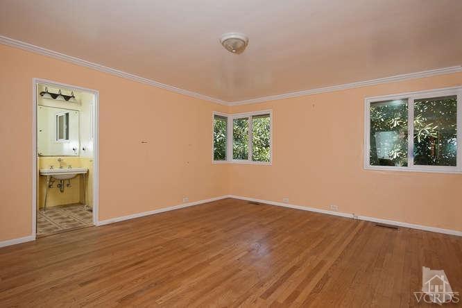 1240 Mark Avenue Carpinteria, CA 93013 - Photo 11 of 20 an empty room with wooden floor and windows