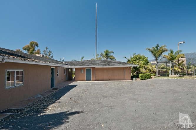 1240 Mark Avenue Carpinteria, CA 93013 - Photo 17 of 20 a view of a house with a yard and garage