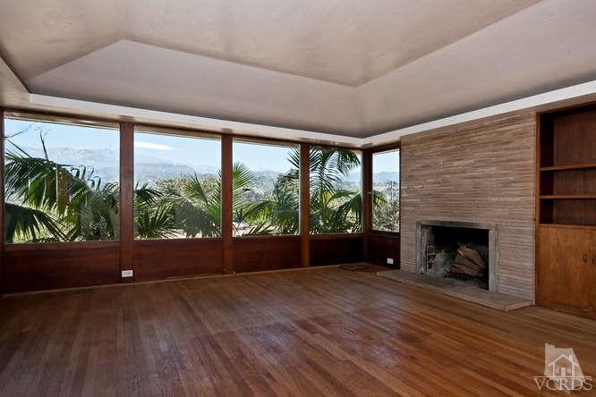 1240 Mark Avenue Carpinteria, CA 93013 - Photo 3 of 20 a view of empty room with wooden floor and fireplace