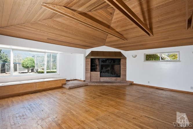 1240 Mark Avenue Carpinteria, CA 93013 - Photo 5 of 20 a view of empty room with wooden floor and fireplace