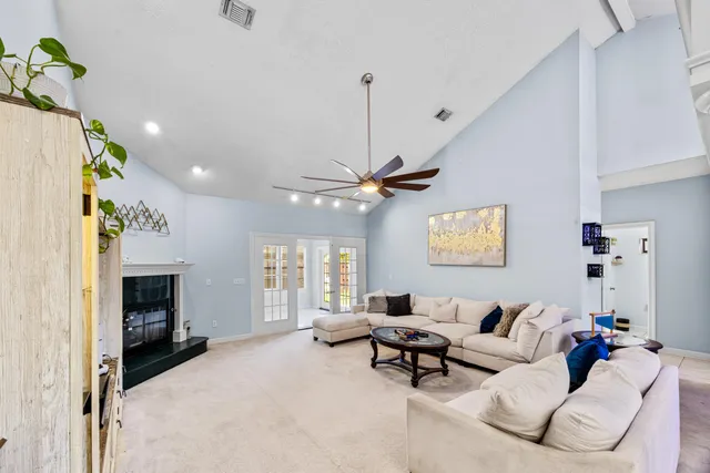 a living room with furniture and a chandelier