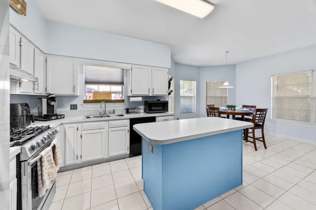 a kitchen with stainless steel appliances a stove a sink and a refrigerator