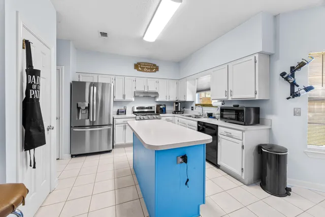 a kitchen with a sink a stove and cabinets