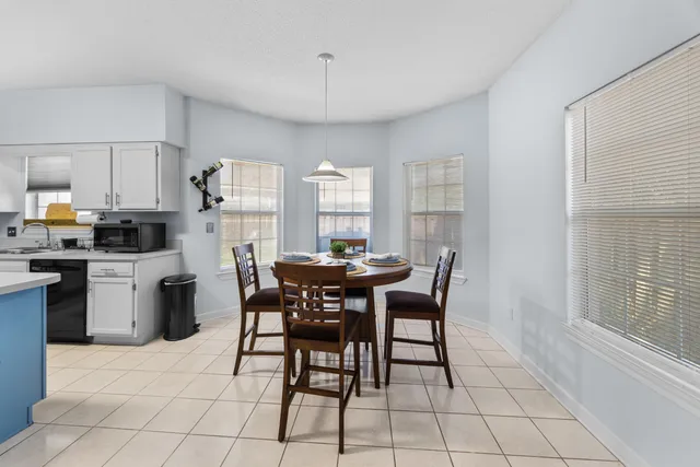 a view of a dining room with furniture and a chandelier