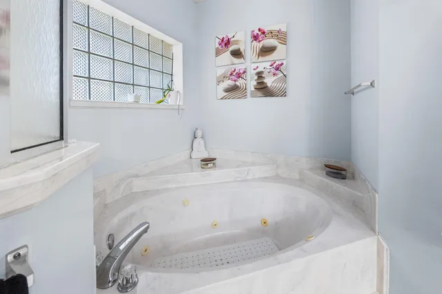 a view of a house with a yard and large tree