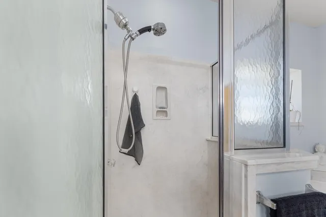 a view of a backyard with potted plants and wooden fence