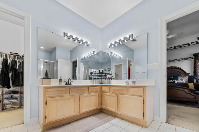 a view of a yard in front of a house with a large tree