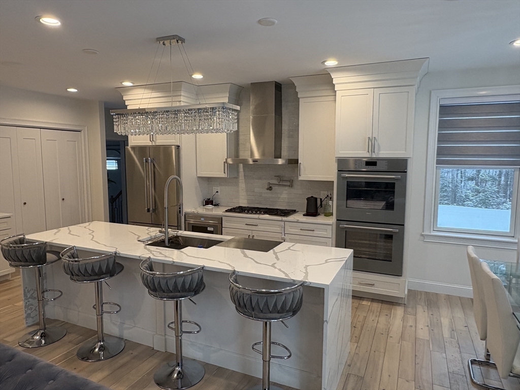 5 Barnard Hill Road Boylston, MA 01505 - Photo 14 of 37 a kitchen with stainless steel appliances kitchen island granite countertop a refrigerator and a stove top oven