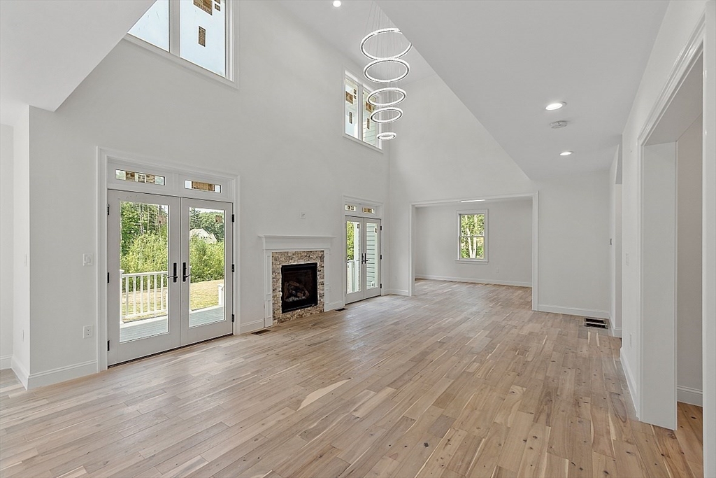 5 Barnard Hill Road Boylston, MA 01505 - Photo 16 of 37 an empty room with wooden floor fireplace and windows