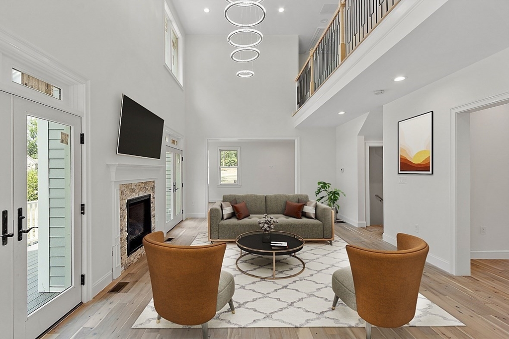 5 Barnard Hill Road Boylston, MA 01505 - Photo 17 of 37 a living room with a couch a flat screen tv and a fireplace
