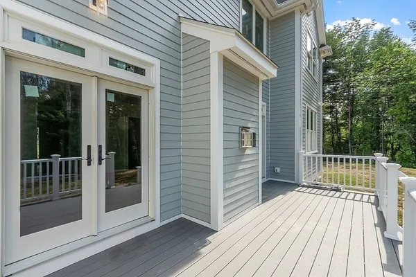 a view of a wooden deck and trees with wooden fence