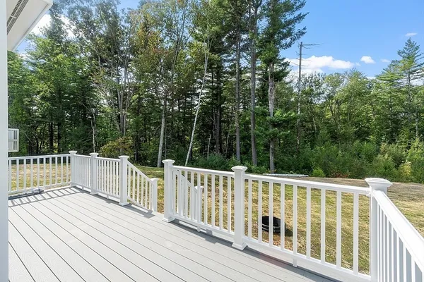 a view of a balcony with wooden floor and fence
