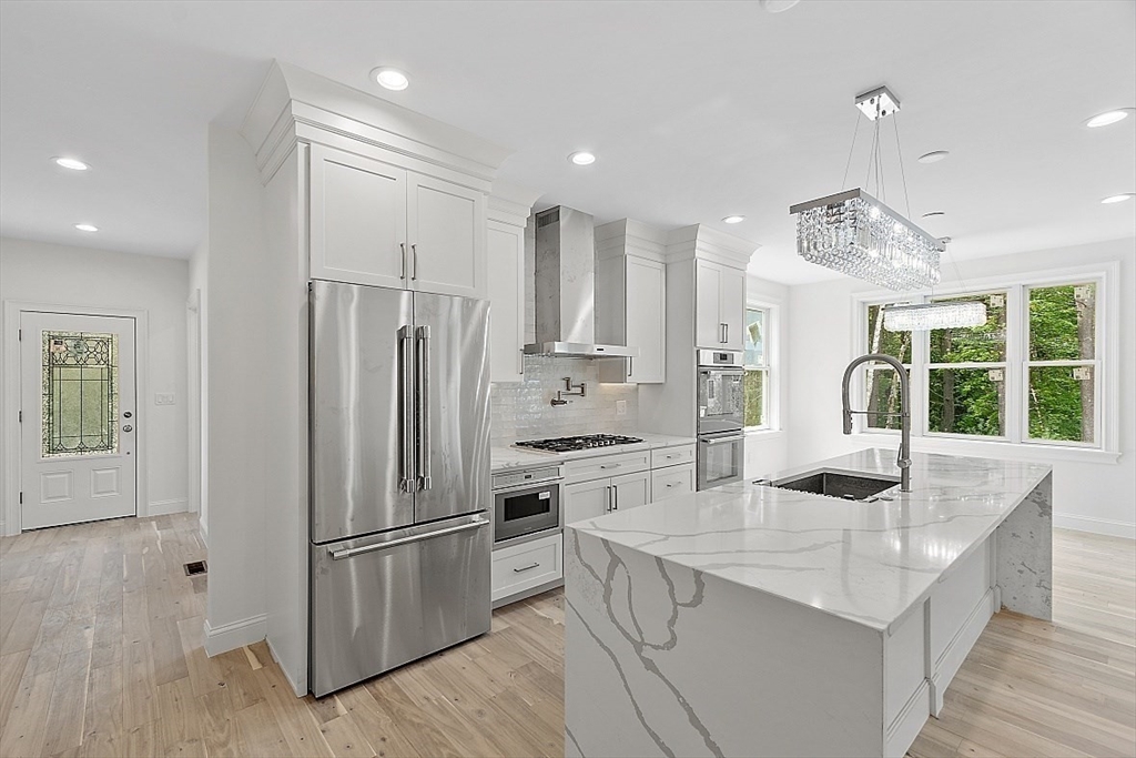 5 Barnard Hill Road Boylston, MA 01505 - Photo 10 of 37 a kitchen with stainless steel appliances a refrigerator a sink a stove a microwave and island