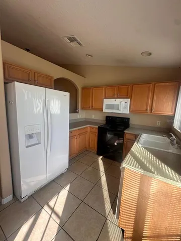 a view of a hallway with wooden shelves