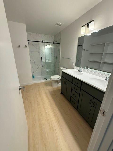 505 Thomas Street Terrell, TX 75160 - Photo 25 of 38 Modern bathroom featuring a dual vanity with dark cabinetry, white countertops, and integrated sinks