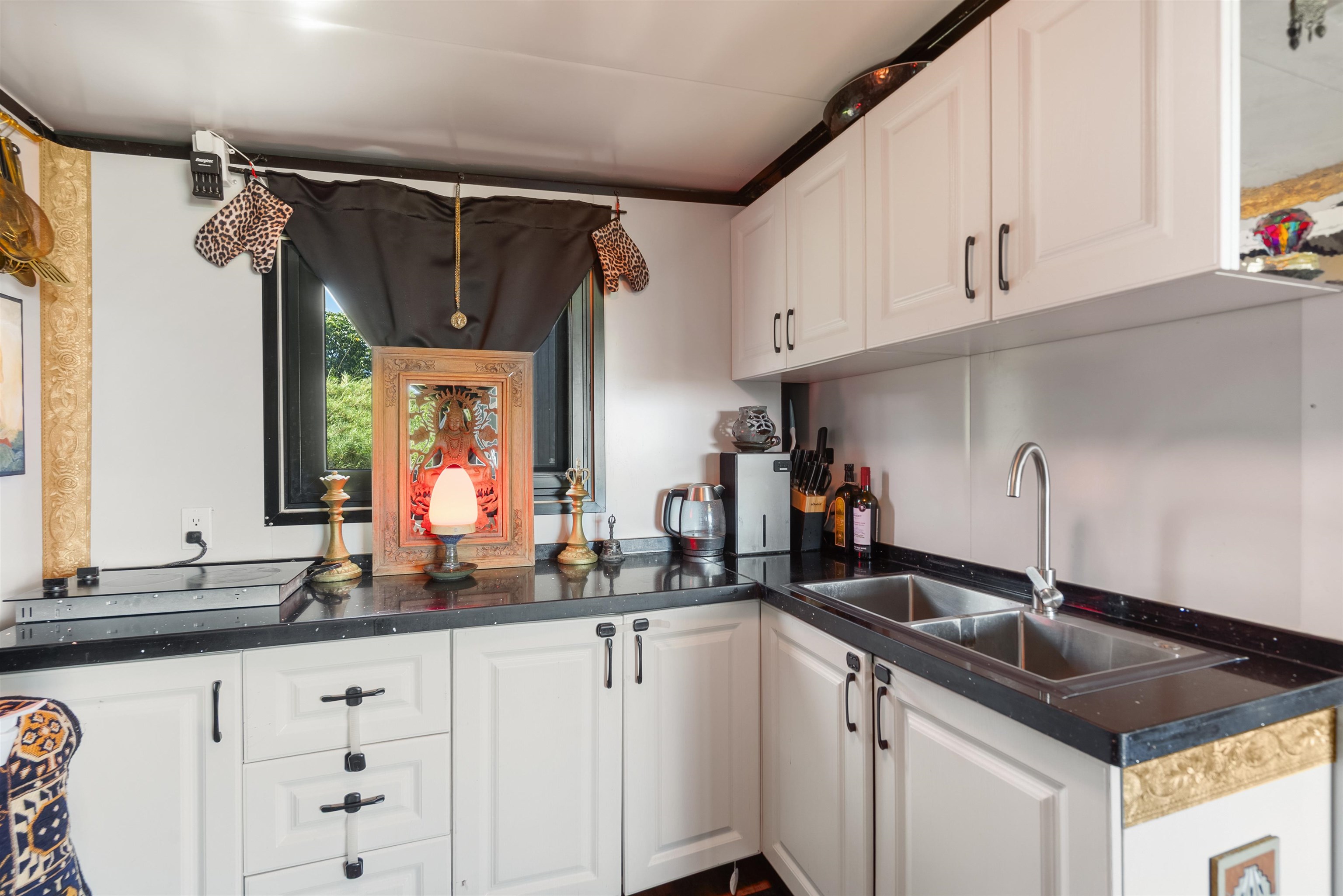 3980 Hana Highway Haiku, HI 96708 - Photo 11 of 33 a kitchen with granite countertop a sink and cabinets