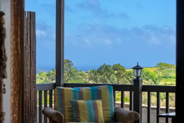 a view of a balcony with couches and wooden floor