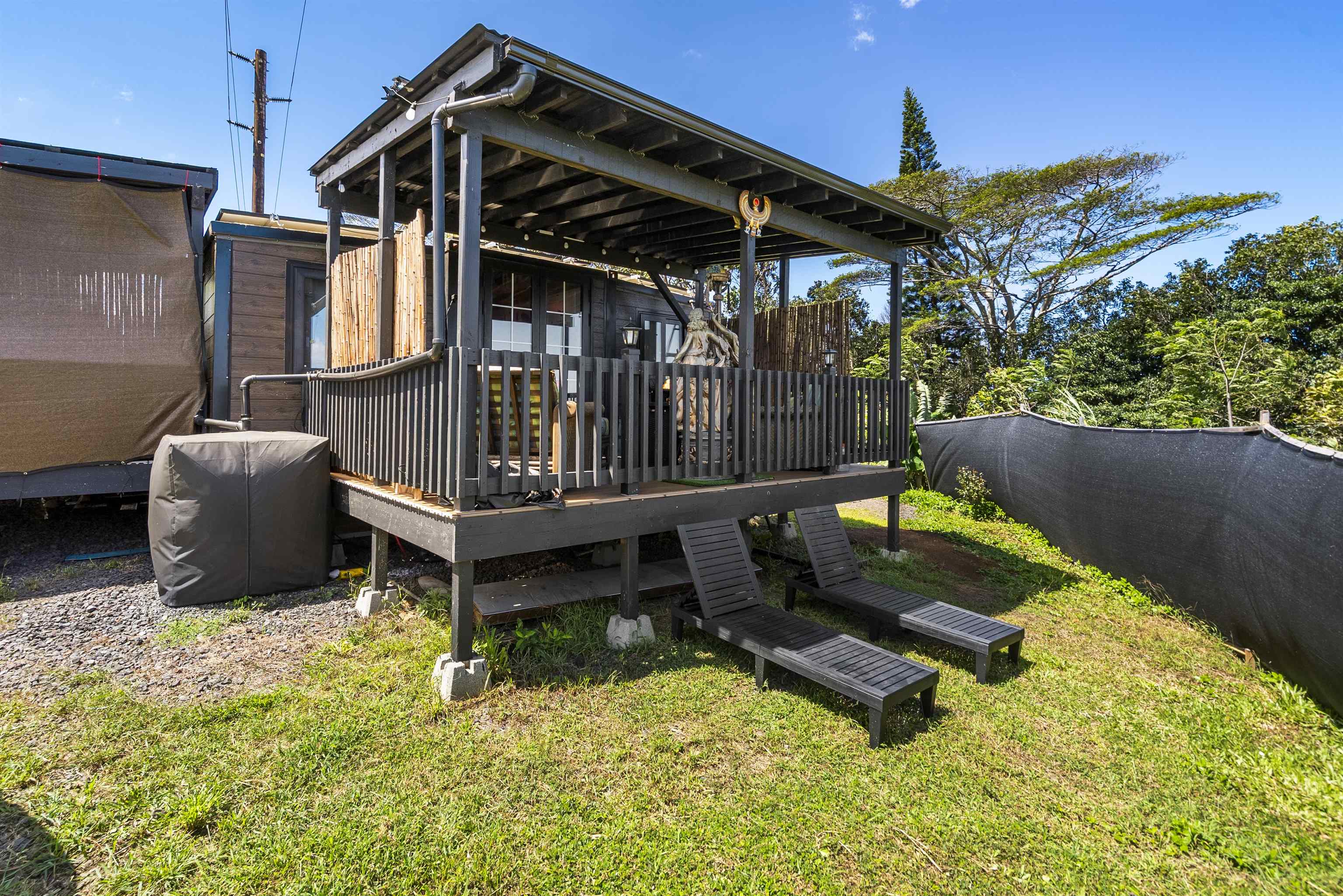 3980 Hana Highway Haiku, HI 96708 - Photo 23 of 33 a view of a backyard with wooden fence and a bench