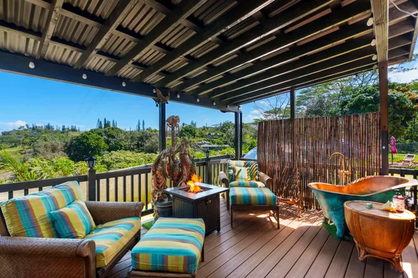 a balcony with wooden floor and outdoor seating