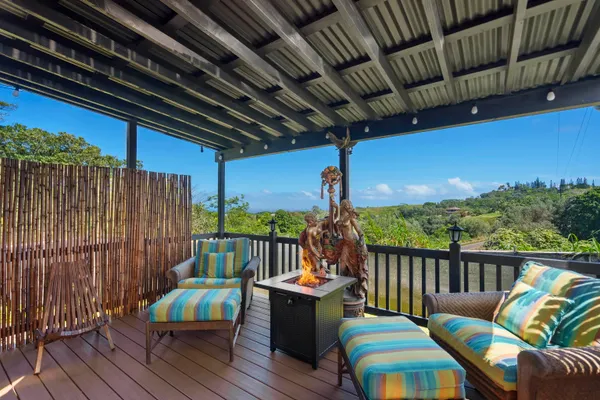 a balcony with furniture and wooden floor
