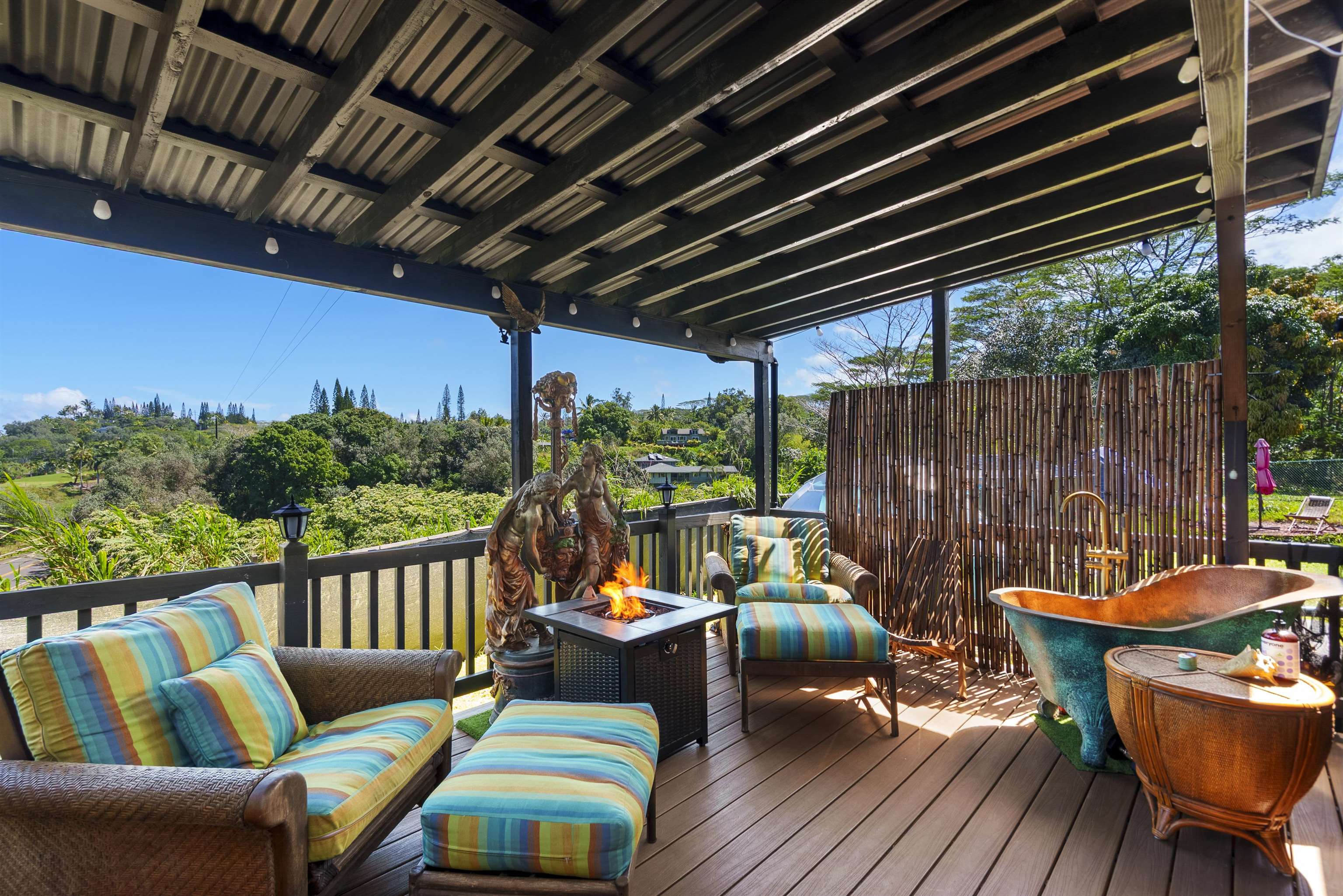 3980 Hana Highway Haiku, HI 96708 - Photo 5 of 33 a balcony with wooden floor and outdoor seating