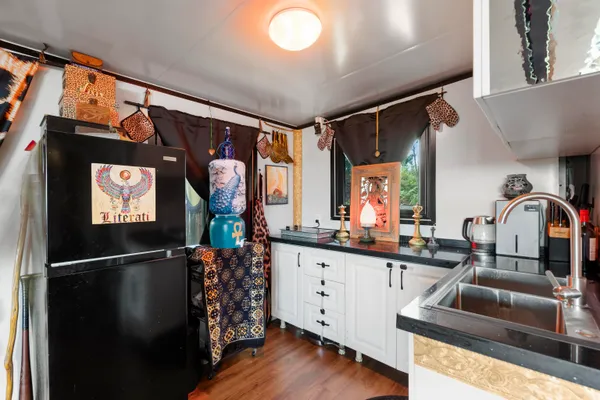 a kitchen with stainless steel appliances granite countertop a sink refrigerator and microwave
