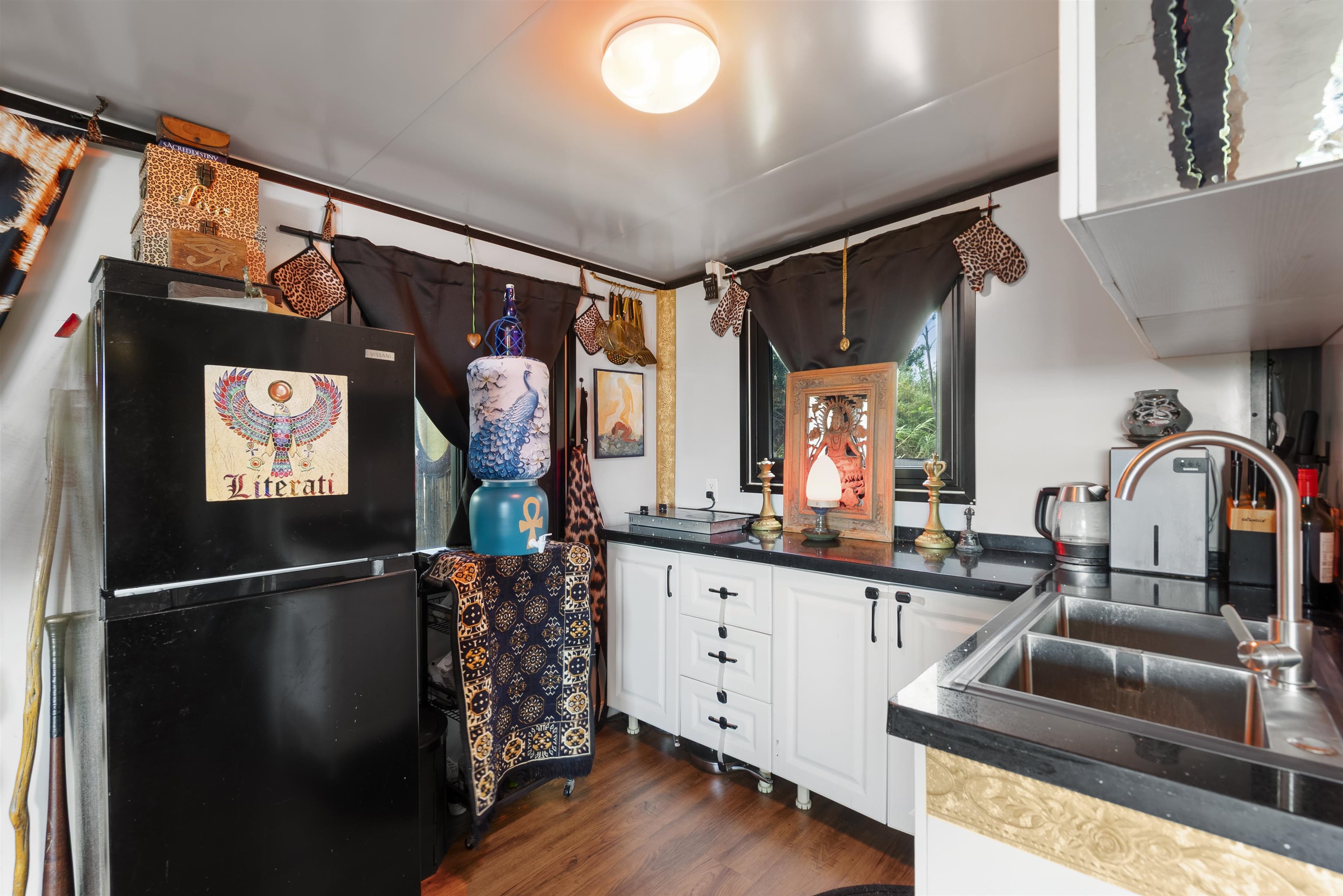 3980 Hana Highway Haiku, HI 96708 - Photo 10 of 33 a kitchen with stainless steel appliances granite countertop a sink refrigerator and microwave