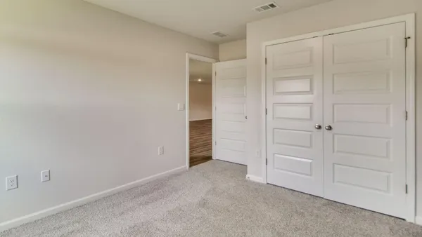 an empty room with closet area