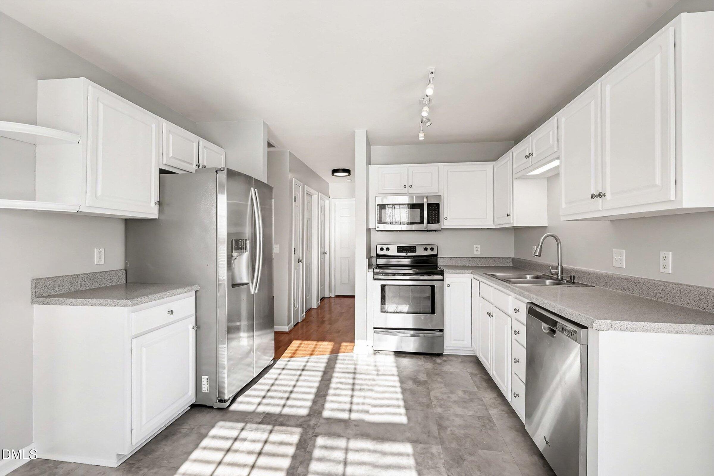 1005 Tesh Court High Point, NC 27265 - Photo 14 of 34 a kitchen with stainless steel appliances granite countertop a refrigerator sink and white cabinets