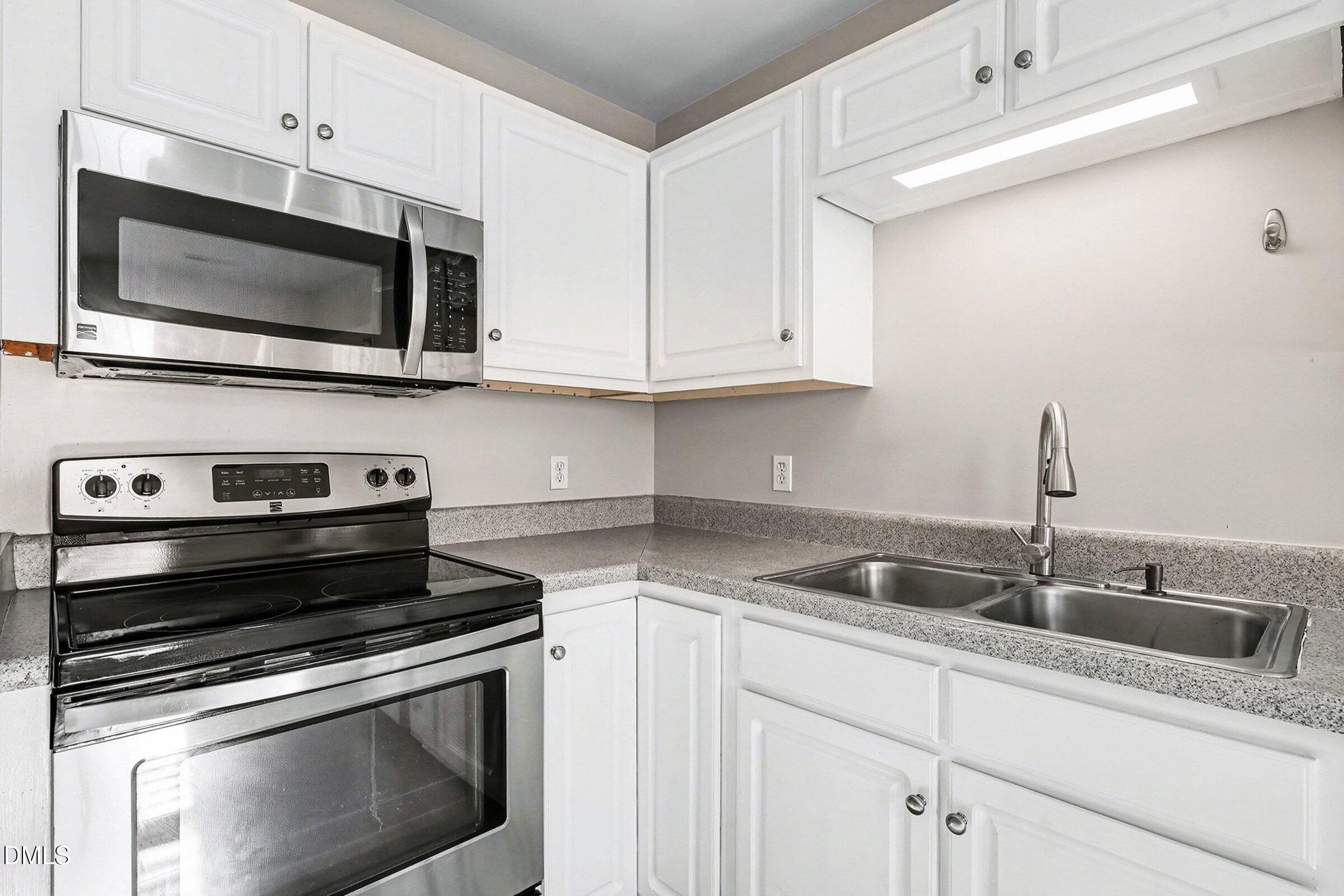 1005 Tesh Court High Point, NC 27265 - Photo 15 of 34 a kitchen with stainless steel appliances granite countertop a sink stove and microwave