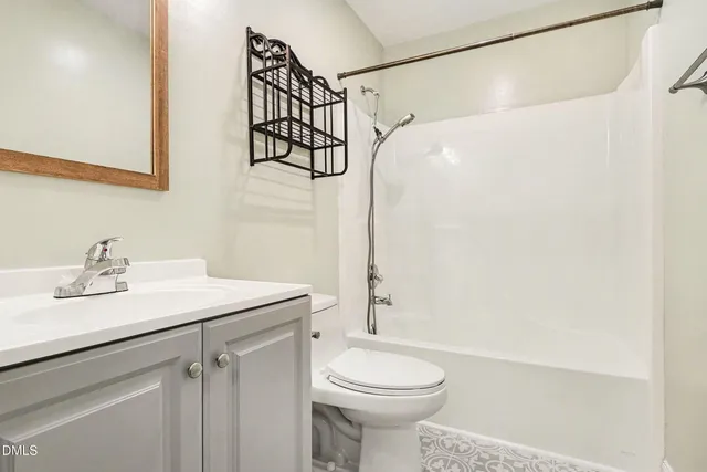 an empty room with chandelier fan