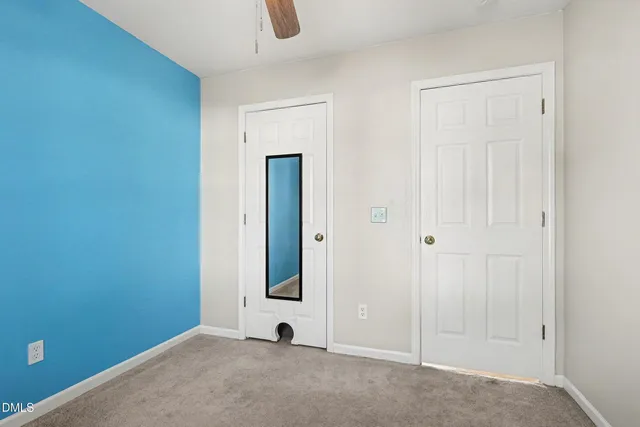 a view of a house with backyard and a tree