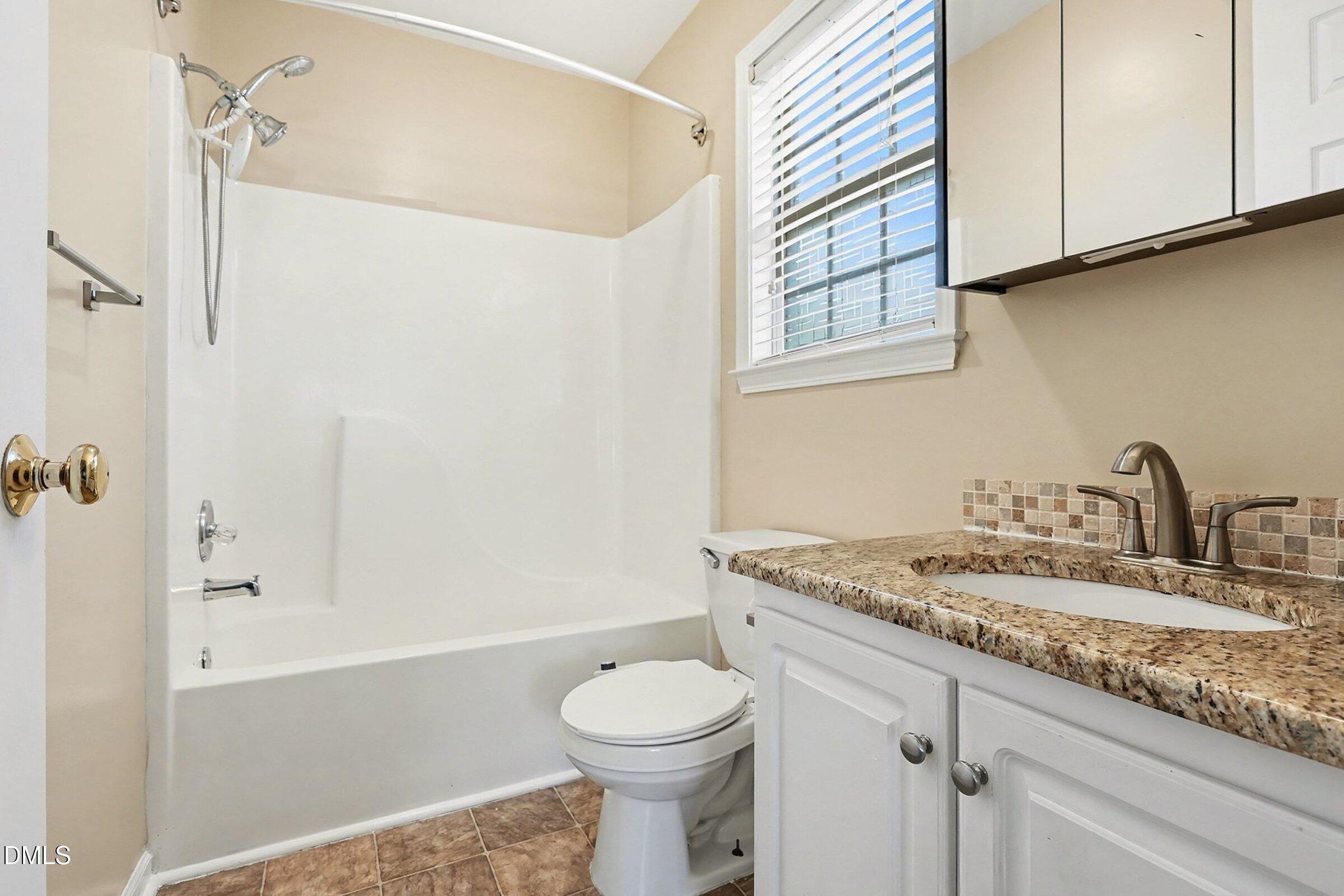 1005 Tesh Court High Point, NC 27265 - Photo 24 of 34 a bathroom with a granite countertop sink toilet and shower
