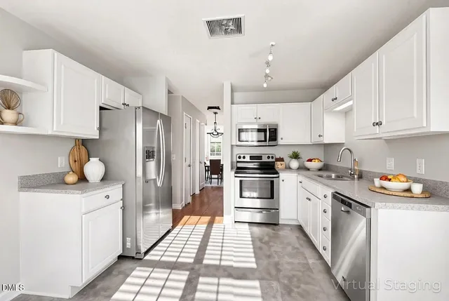 a kitchen with stainless steel appliances a refrigerator stove and sink