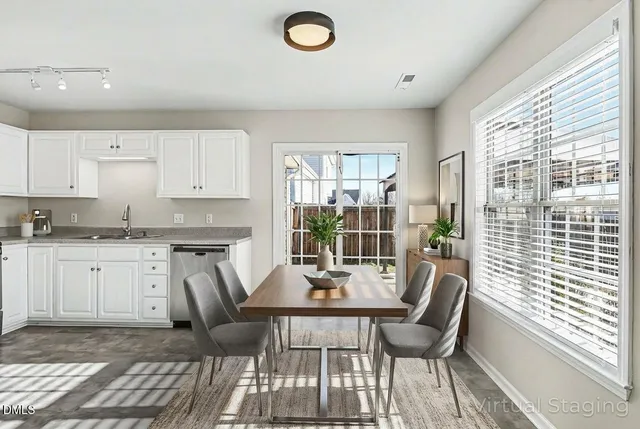 a view of a dining room with furniture and wooden floor