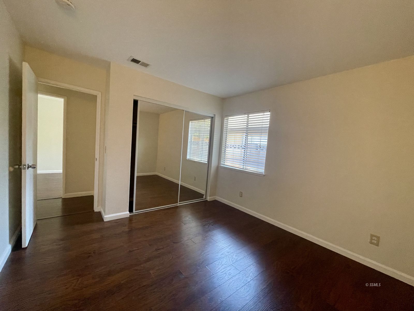 225 East Rader Avenue Ridgecrest, CA 93555 - Photo 19 of 30 an empty room with wooden floor and windows