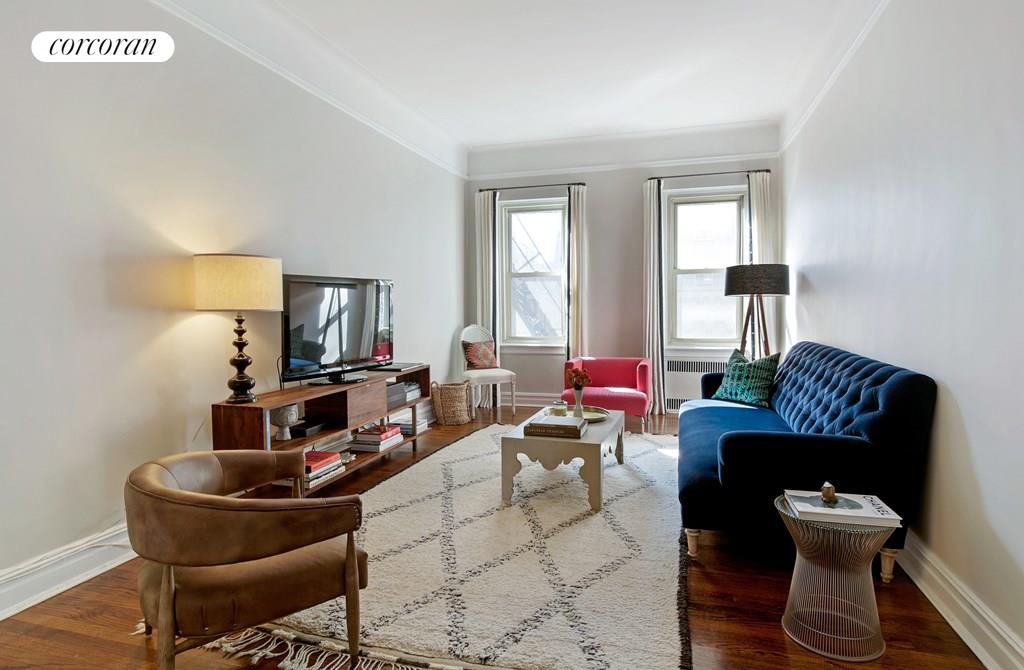 55 Pineapple Street, Unit 5D Brooklyn, NY 11201 - Photo 1 of 1 a living room with furniture and a flat screen tv