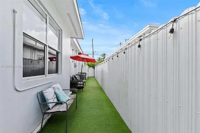 a backyard of a house with table and chairs