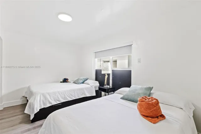 a bedroom with two beds and a couch