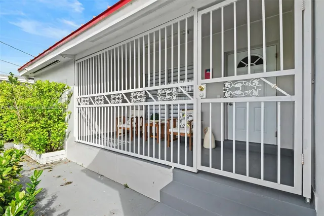 a view of a balcony with a floor to ceiling window and wooden fence